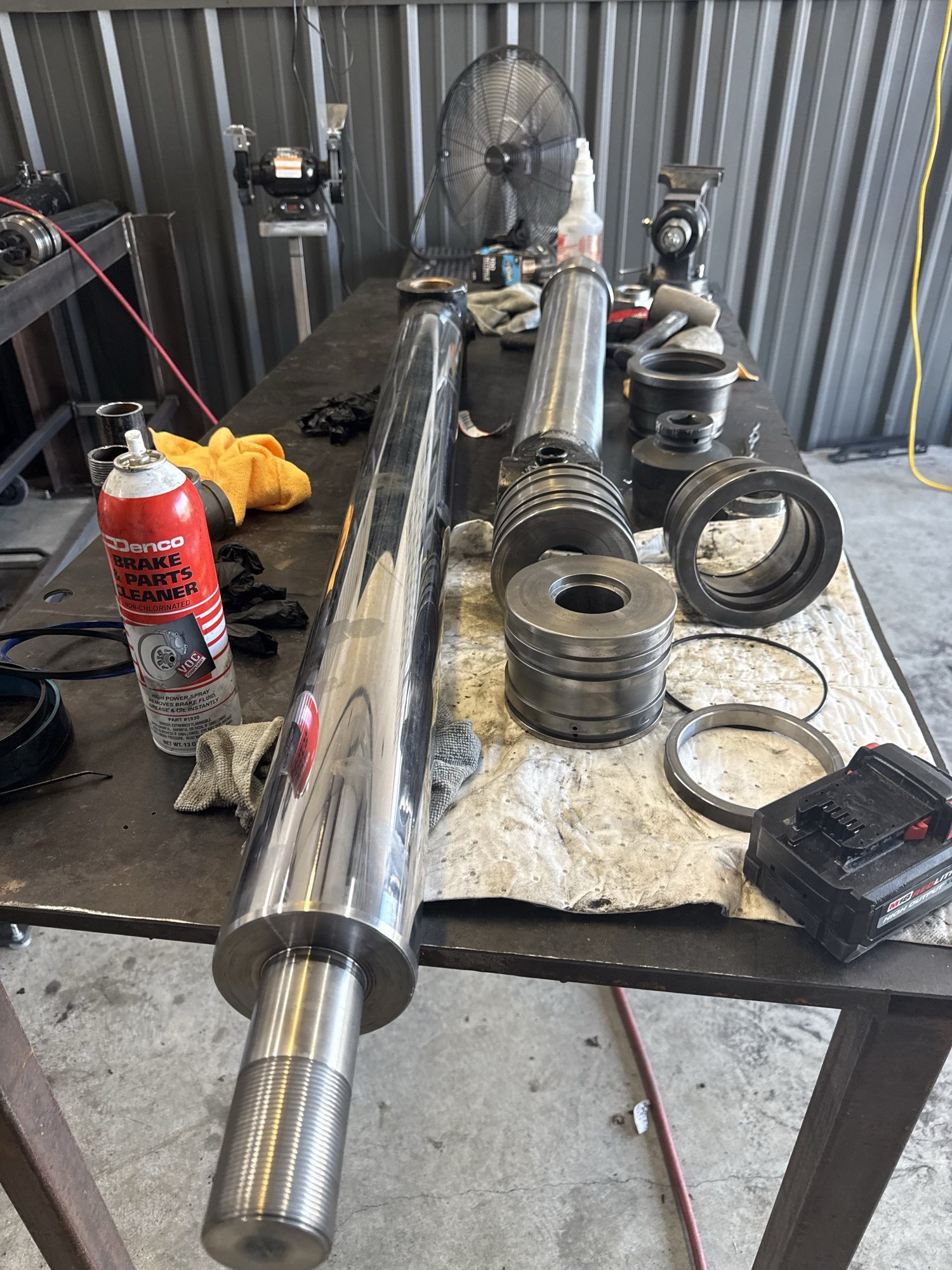 Rebuilt hydraulic cylinder rod and fittings on a repair stand