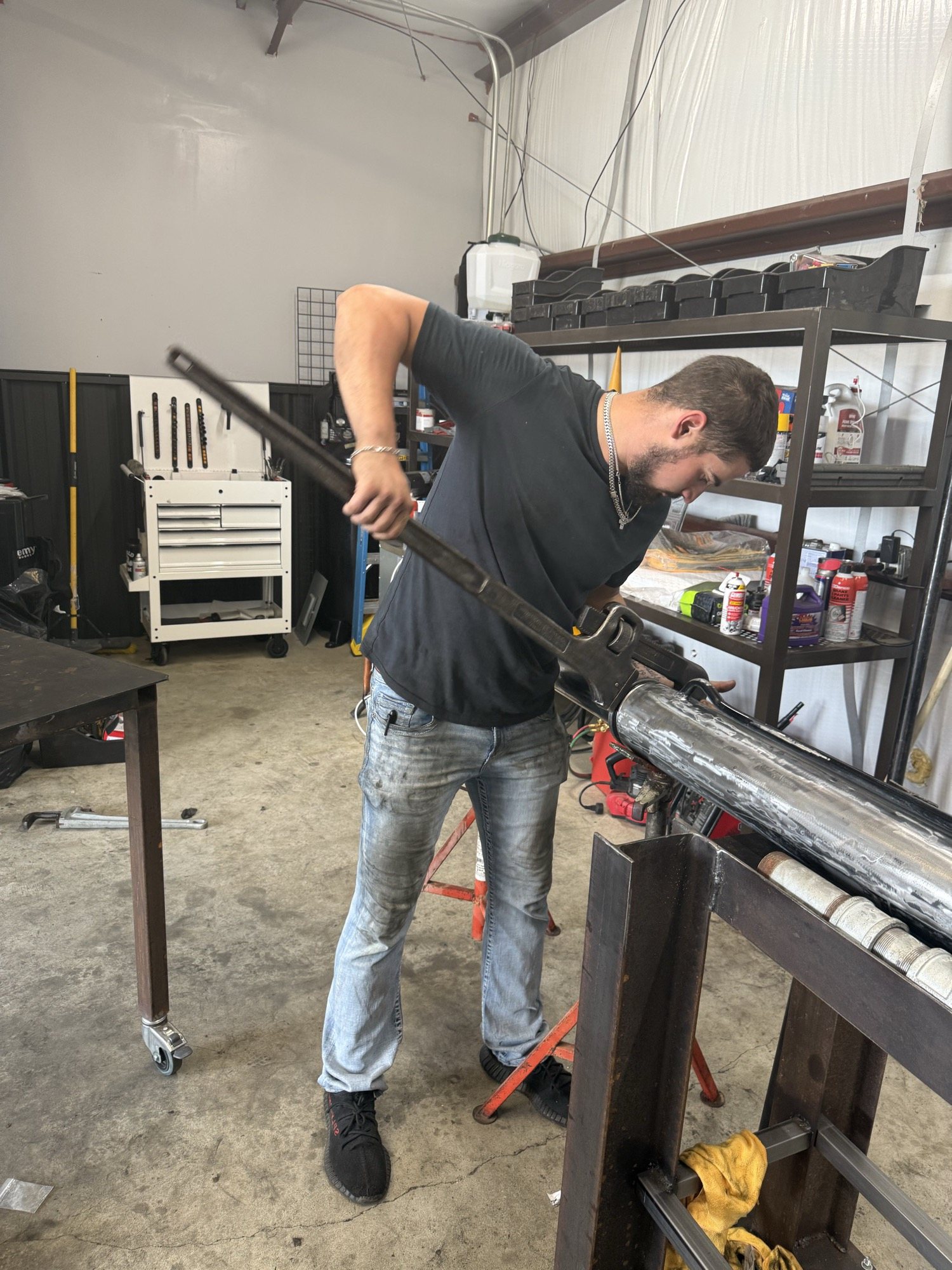 Technician handling a hydraulic cylinder during repair